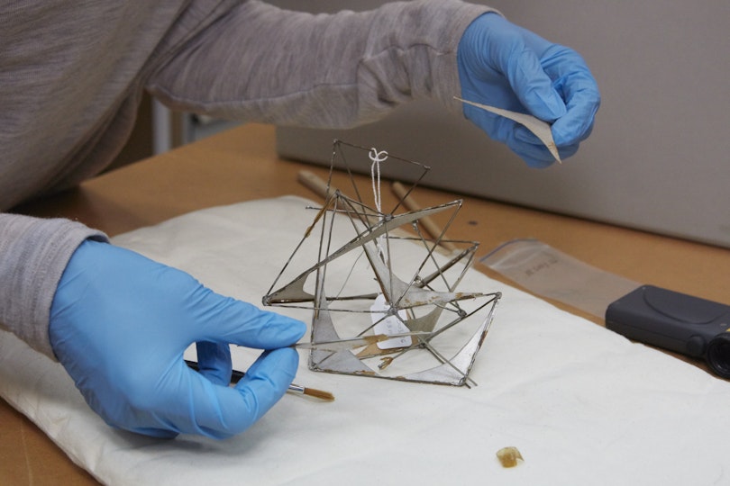 Objects conservator Melanie Barrett working on a Margel Hinder maquette for the Conservation Benefactors group.