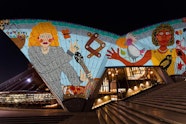 Render of Kaylene Whiskey’s work Dolly visits Indulkana 2020 projected onto the Sydney Opera House’s eastern Bennelong sails as part of Badu Gili: Wonder Women. Image credit: Courtesy Sydney Opera House