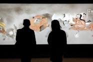 Visitors enjoying the Japan Supernatural interactive touch wall featuring characters from Hiroharu Itaya Night procession of one hundred demons circa 1820 (detail)