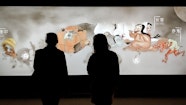 Visitors enjoying the Japan Supernatural interactive touch wall featuring characters from Hiroharu Itaya Night procession of one hundred demons circa 1820 (detail)