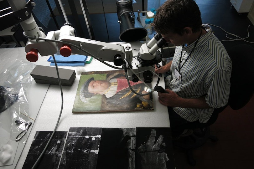 Paintings Conservator Simon Ives investigates King Henry VIII prior to treatment. Project supported by the Conservation Benefactors.