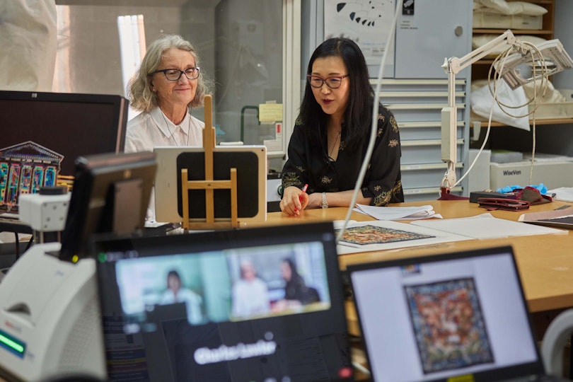 Kerry Head, AGNSW senior objects conservator, and Yin Cao, AGNSW curator of Chinese art, during an online knowledge exchange on the specialist areas of lacquerware and textiles with staff from the Palace Museum in Beijing. Project supported by Bank of China.
