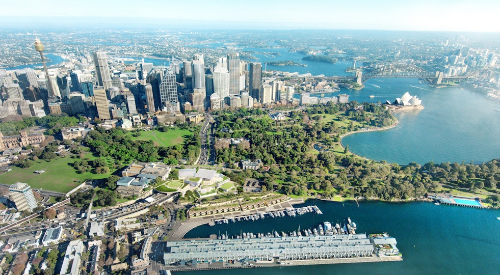 An aerial view of Sydney Harbour including the Art Gallery of New South Wales in the mid foreground and the Sydney Harbour Bridge and Sydney Opera House in the top left