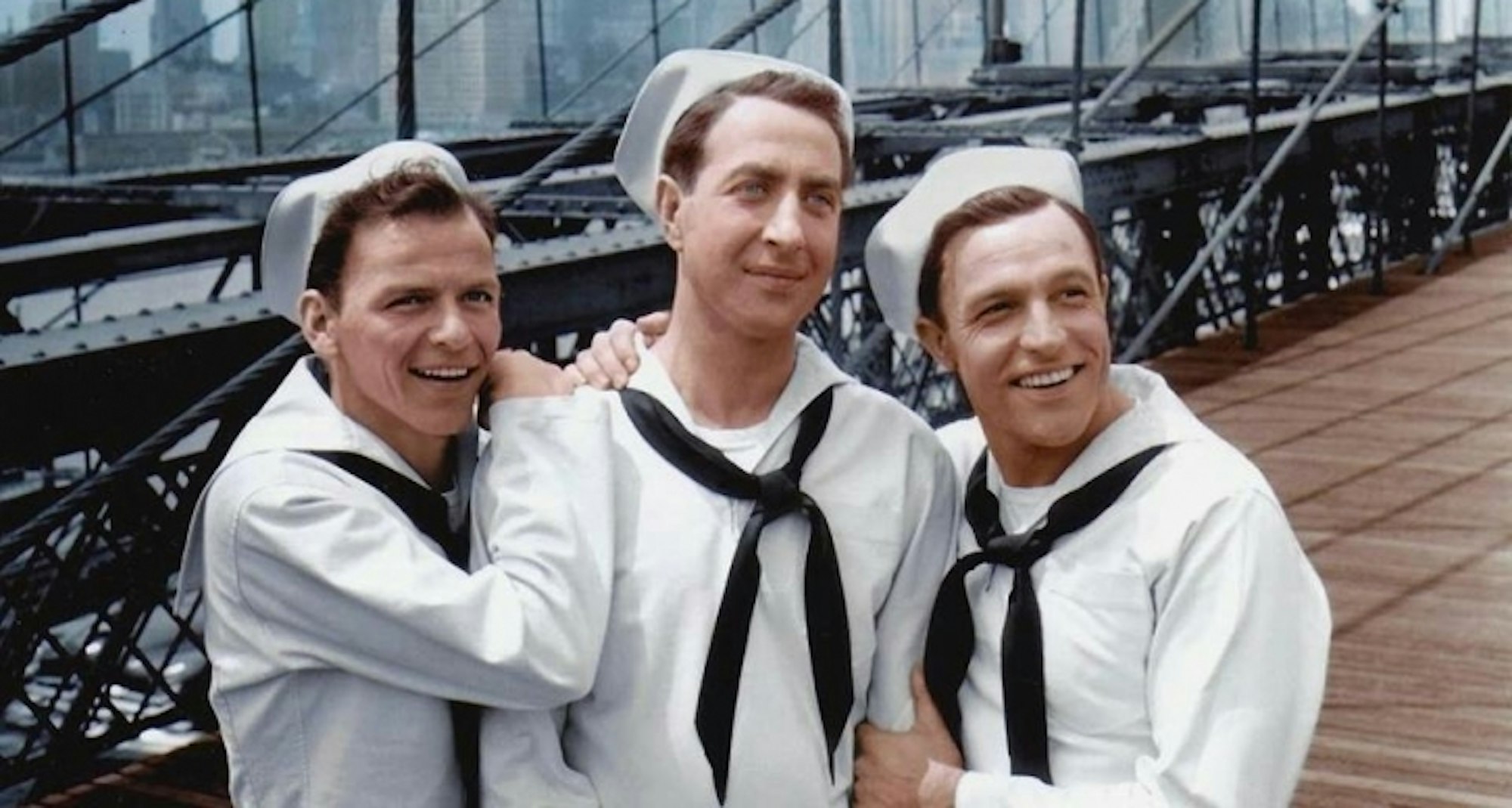Video still of 3 people in sailor's uniforms on Brooklyn Bridge in New York.
