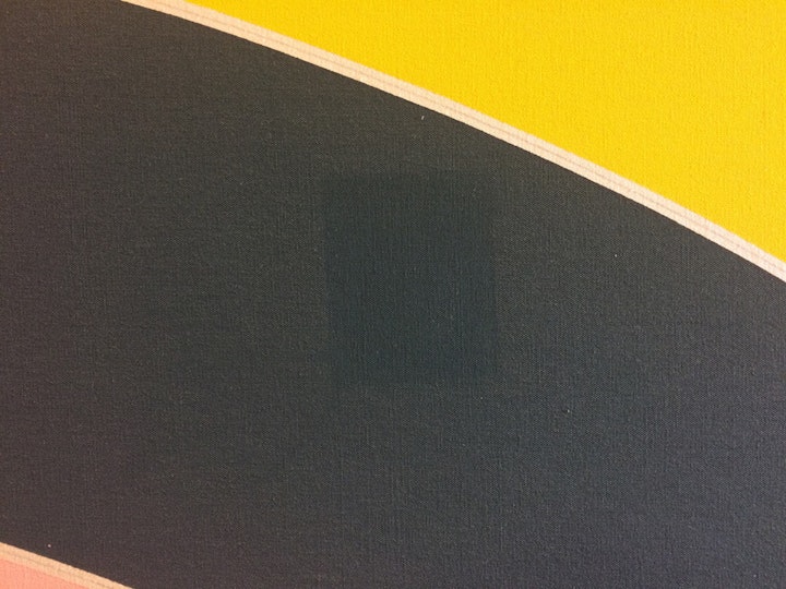 A thick layer of dust was de-saturating the originally bright colours, so conservation treatment started with dusting the front, back and tacking edges of the artwork with a soft brush, vacuum and smoke sponge (a drycleaning sponge made of vulcanised natural rubber). You can clearly see the difference before and after dusting in this image.