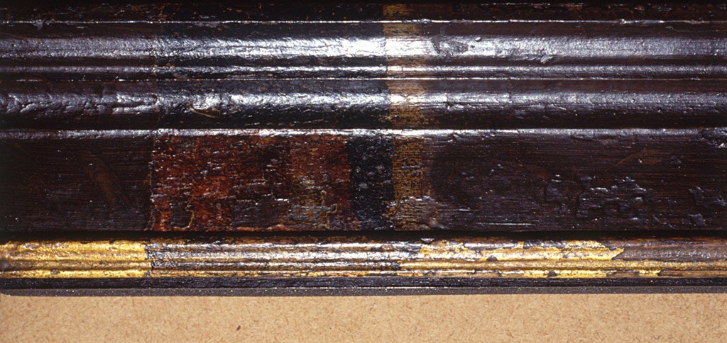 Detail of the NPG’s Henry VIII frame showing the surface investigation to identify the painted layers and original finish.