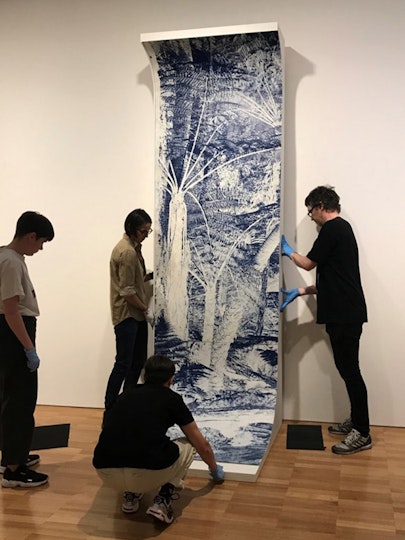 The panels are moved into place in the exhibition space