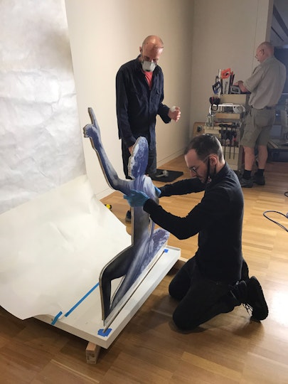 The figure is slotted into place in the panel.