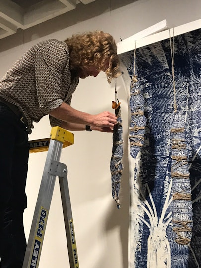 Danie Mellor adjusts the suspended elements