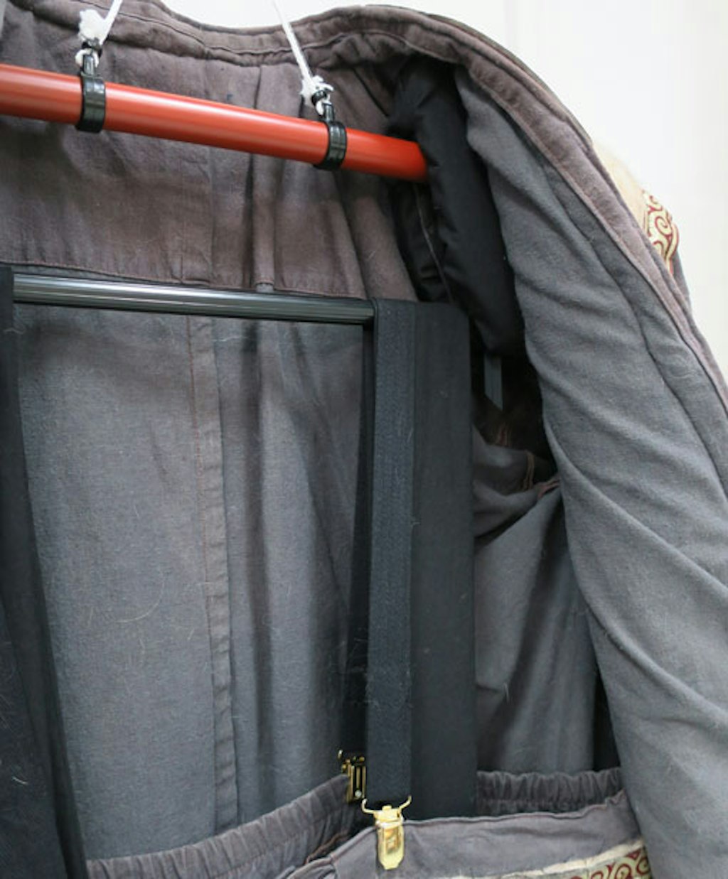 The display hanger with additional supports for the coat and pants