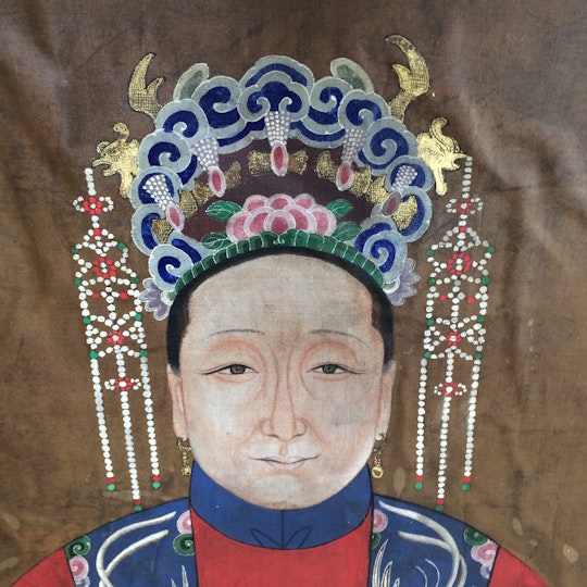 A detail of the wife portrait showing buckling (including separation of the support layers) and staining from water, or simply moisture, damage.