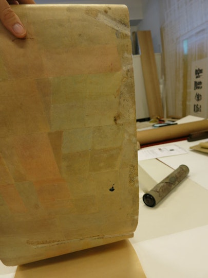 Rolling and unrolling of the ??Colour music?? piano roll over time had resulted in significant wear and extensive tearing.  In this image, several tears can be seen along the edges of the roll, most with poor-quality tape repairs, which have discoloured the paper.