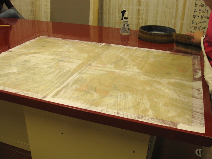 h3. Relining with Chinese paper
To provide additional reinforcement and to simulate the linen lining, each poster was double-lined with two different types of paper, each with different properties. The first layer was Chinese Xuan paper, a strong, smooth paper with a high resistance to mould.