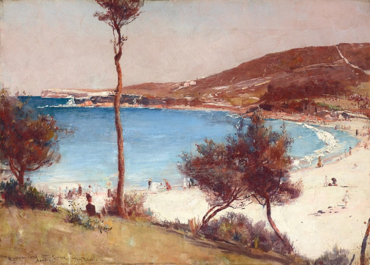 A view of a bay with grassy hills and people on a sandy beach