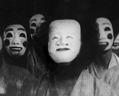 7 people wearing masks with laughing expressions looking direcly into the camera.