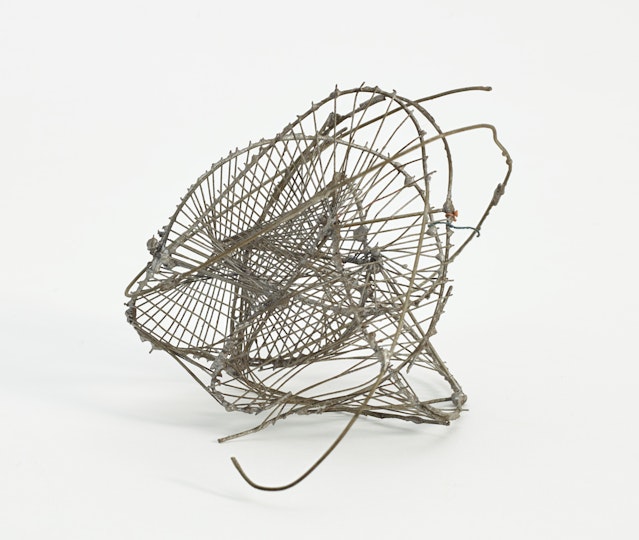 Silver-coloured wire sculpture with looping forms and criss-crossing lines.