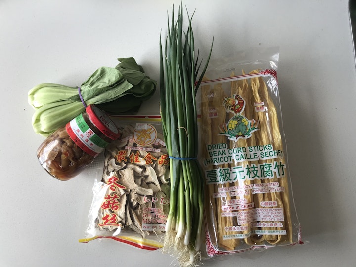 Bok choy, jar of pickles, packet of sliced dried mushrooms, spring onions, packet of dried bean curd sticks.