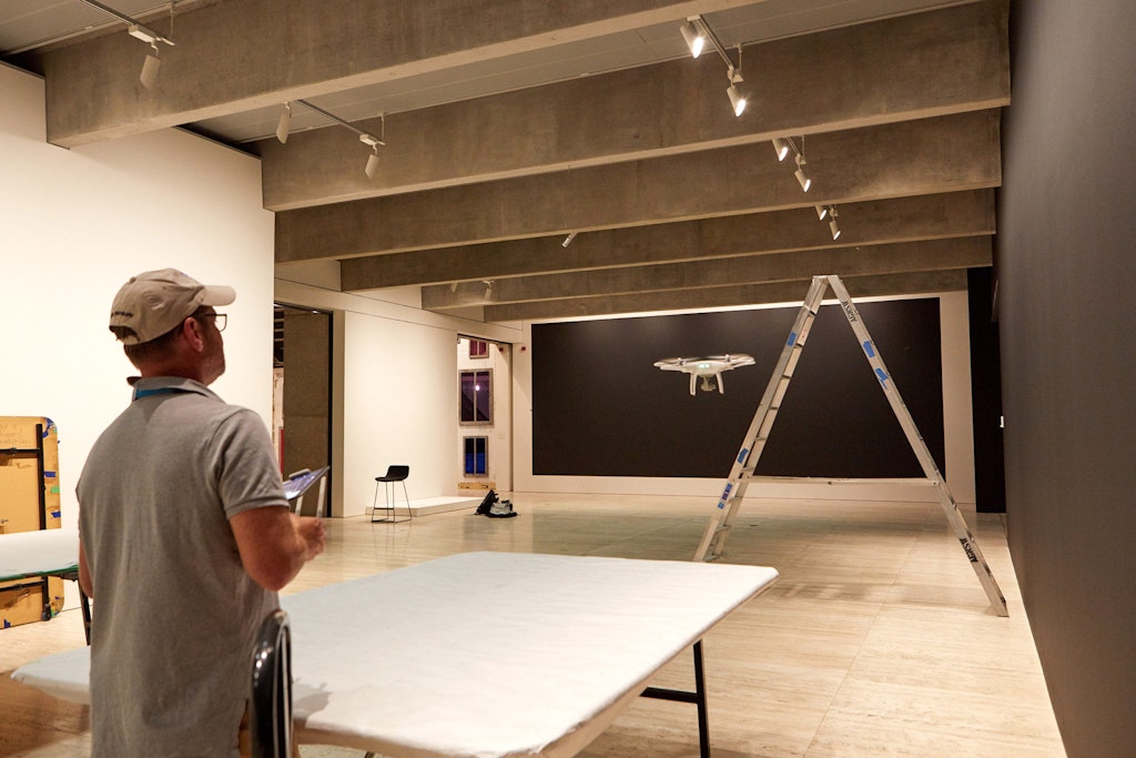 Craig Willoughby from Skyview Aerial Photography guides a drone through the Gallery spaces in preparation for filming
