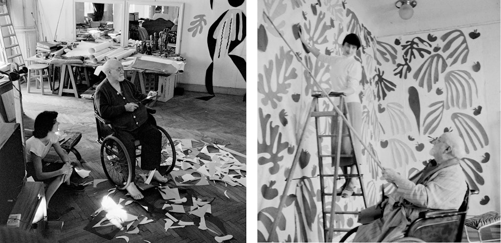Black-and-white photographs of a man in a wheelchair. The first in a studio surrounded by cut-out paper on the floor, with a woman crouched beside him. In the other photo, he points with a large stick to abstract shapes on a wall, and a woman stands on a ladder.
