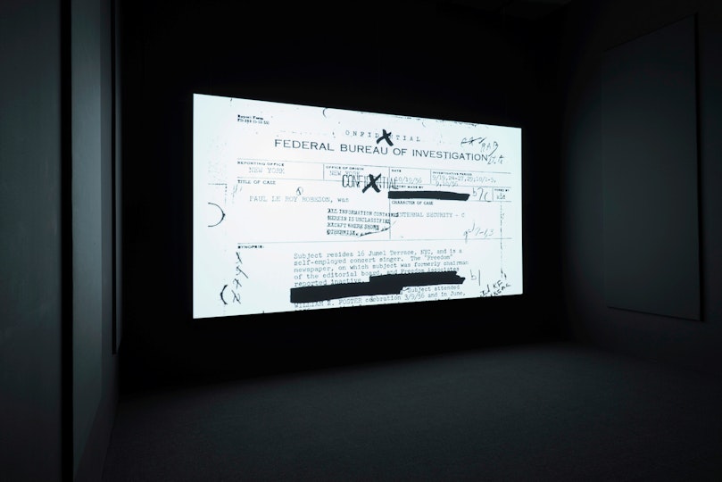 Black-and-white image on a screening of a document headed 'Federal Bureau of Investigation' with redacted sections and annotations.