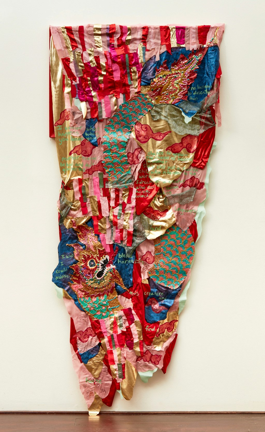 Colourful, irregular-shaped textile artwork hanging on a wall.