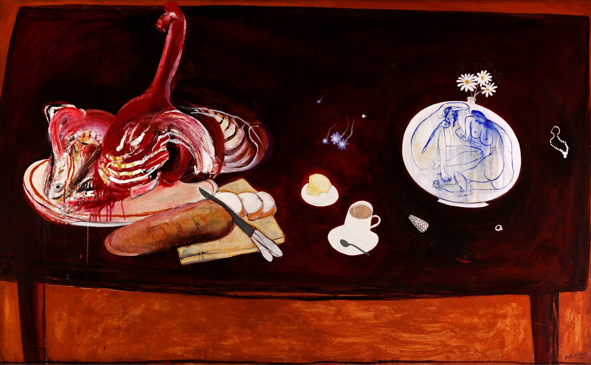 A table with a blue and white round vase holding daisies as well as a cup and saucer, a small plate, a loaf of bread and knife on a board and a platter of meat.