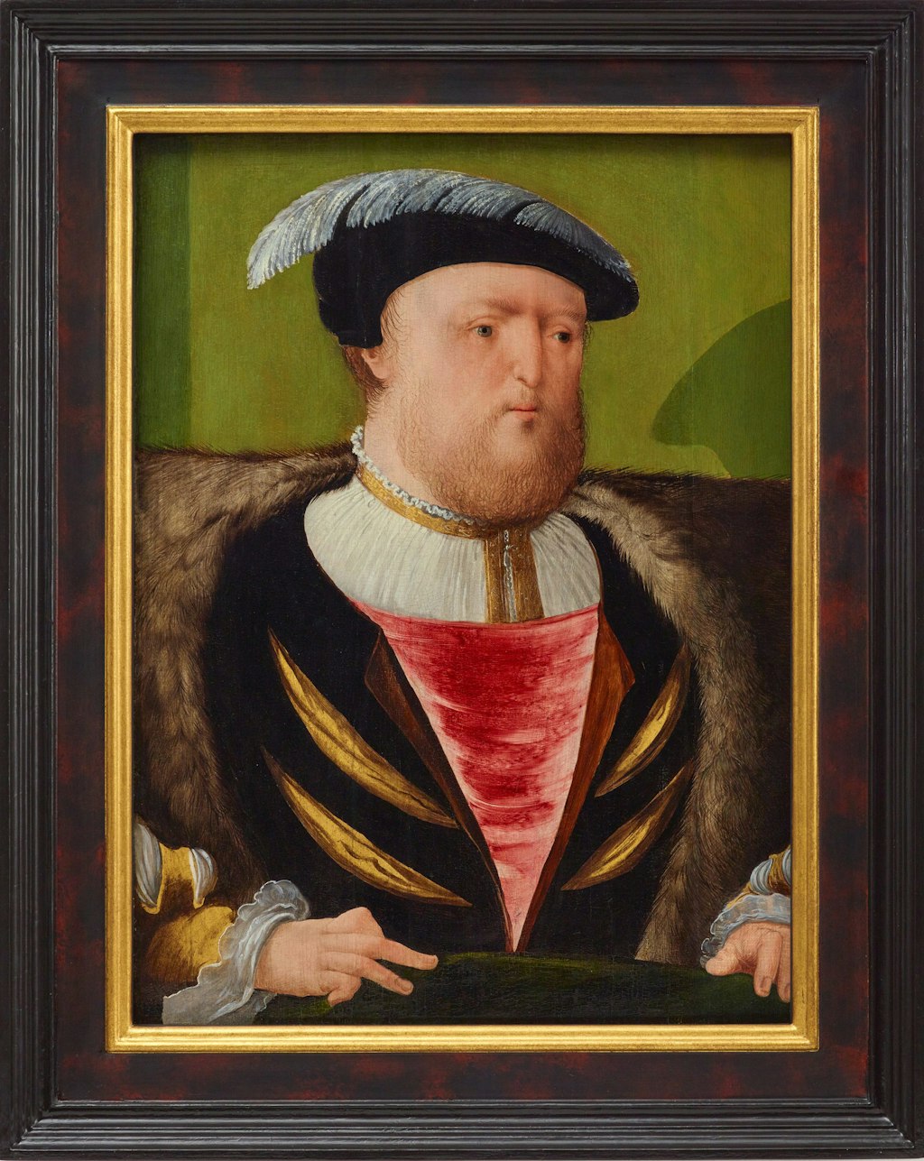 A painting of a bearded man framed in a dark timber frame with gilded inner frame.