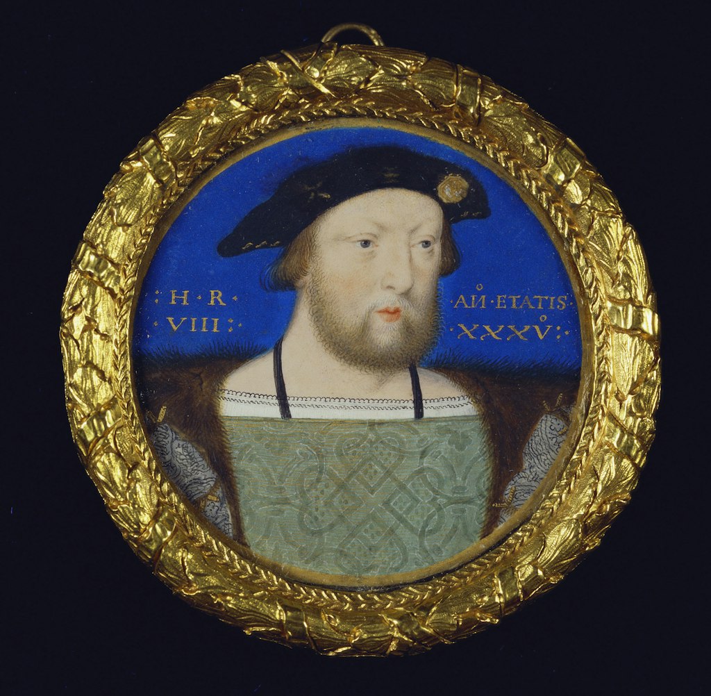 A circular painting of a bearded man in an ornate gold circular frame.