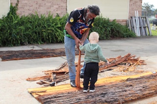Uncle John Kelly leading a bark canoe workshop at Dalaigur Pre-School, Kempsey, NSW. Photo by Stacey Trickett