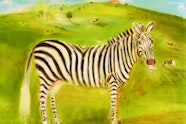 A zebra stands in a green field with cows on a hill behind.