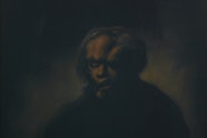A dark figure with a large head is barely discernible on a dark background.