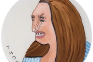 A circular portrait of long-haired portrait with a foot for a nose