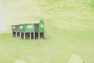 Three houses on stilts on a green ground.