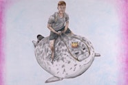 A short-haired barefoot person wearing shorts, t-shirt and a backpack holds the reins of the large crown-wearing seal on which they sit