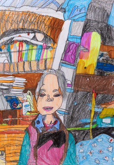 A person sits among many objects in a room