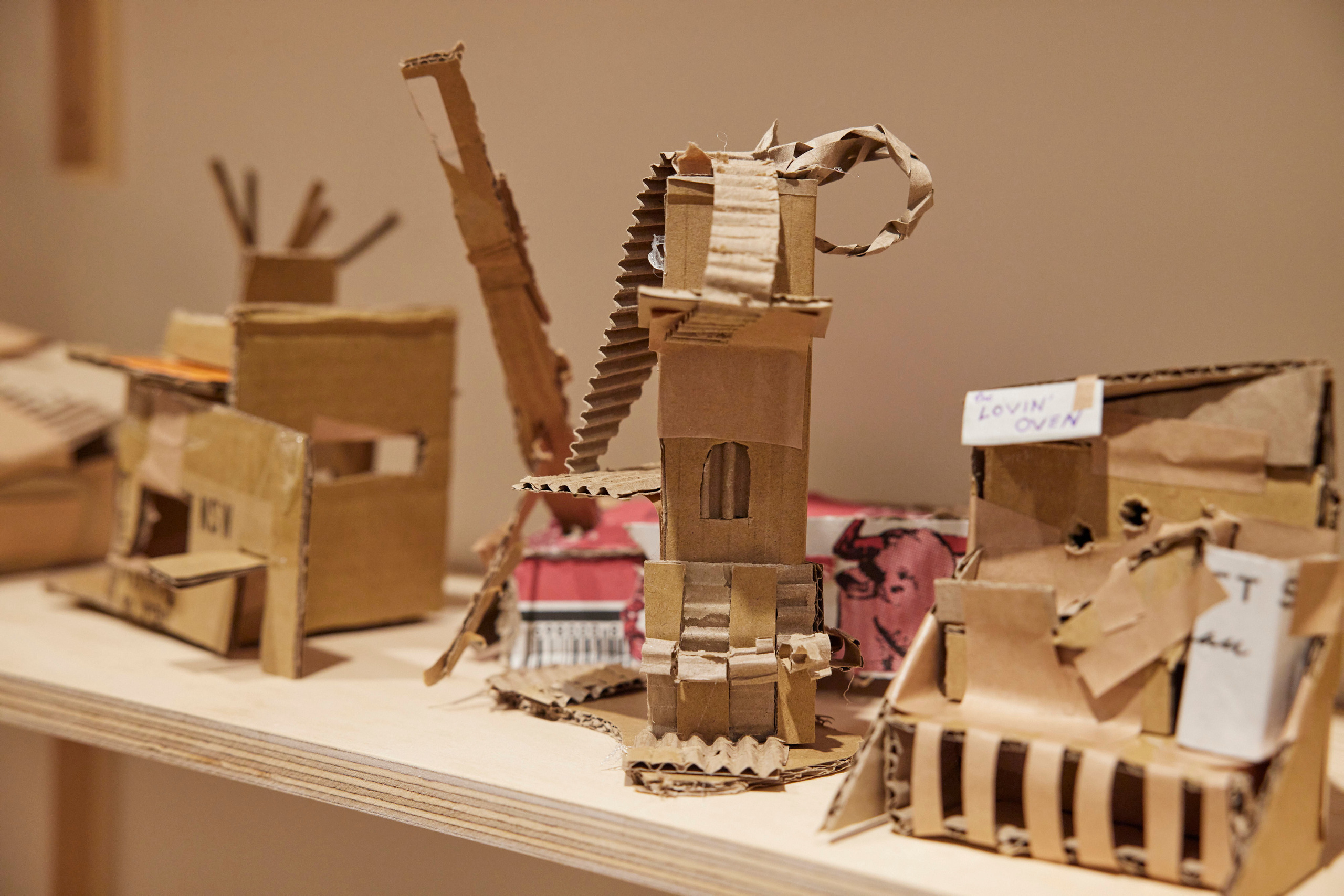 Small cardboard structures on a shelf