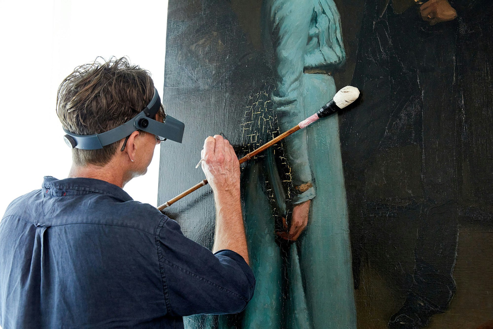 Hugh Ramsay's The blue dress mid-conservation treatment in the conservation laboratory at the Art Gallery of New South Wales