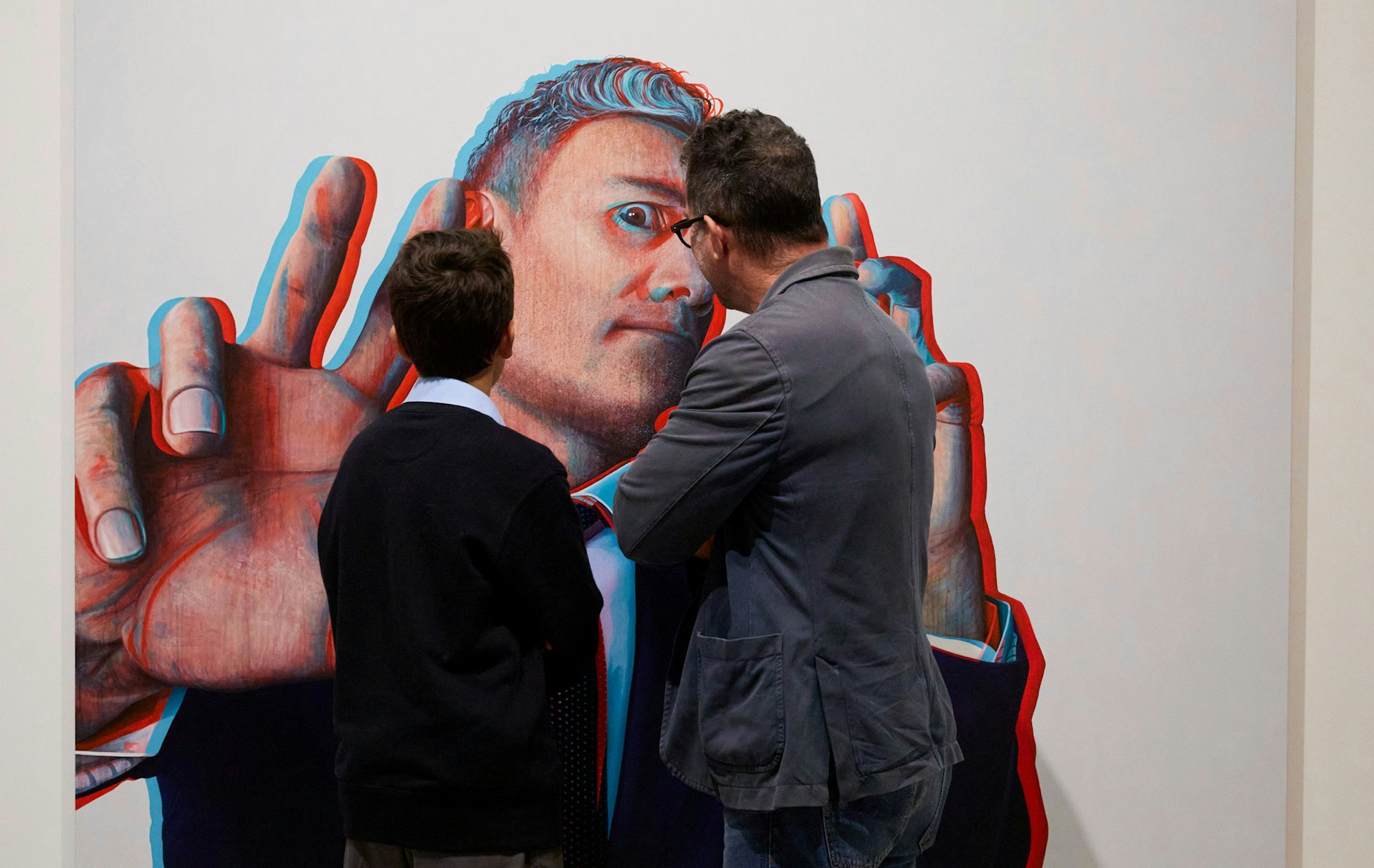 Members with Claus Stangl's portrait of Taika Waititi, which won the Packing Room Prize 2022. Artwork © the artist