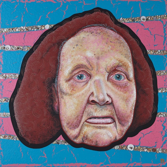 The head of a person with chin-length hair on a pink and blue striped background