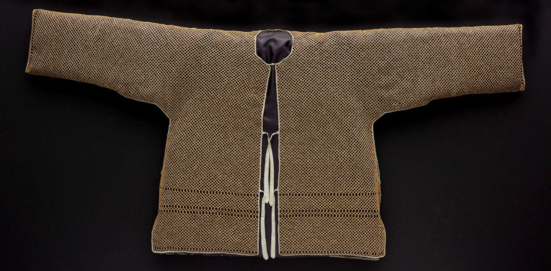 A woven long-sleeved top with a tied front opening