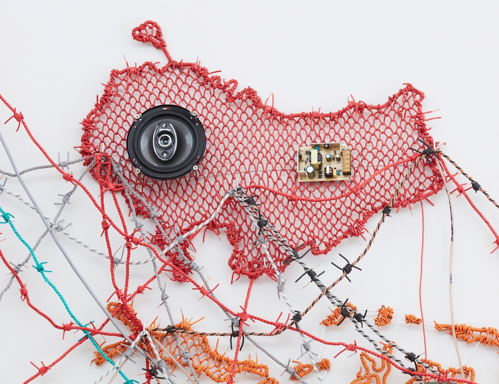 An upside-down map of Australia made of woven wire and audio components