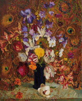 A still-life arrangement of various flowers in a vase with a background of peacock feathers and patterned wallpaper