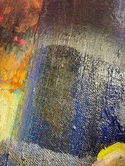 A close-up image of paint in various colours, including blue