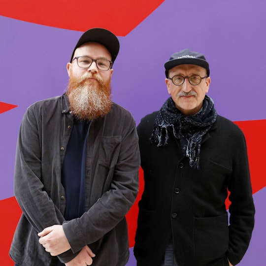 Two people wearing caps and glasses