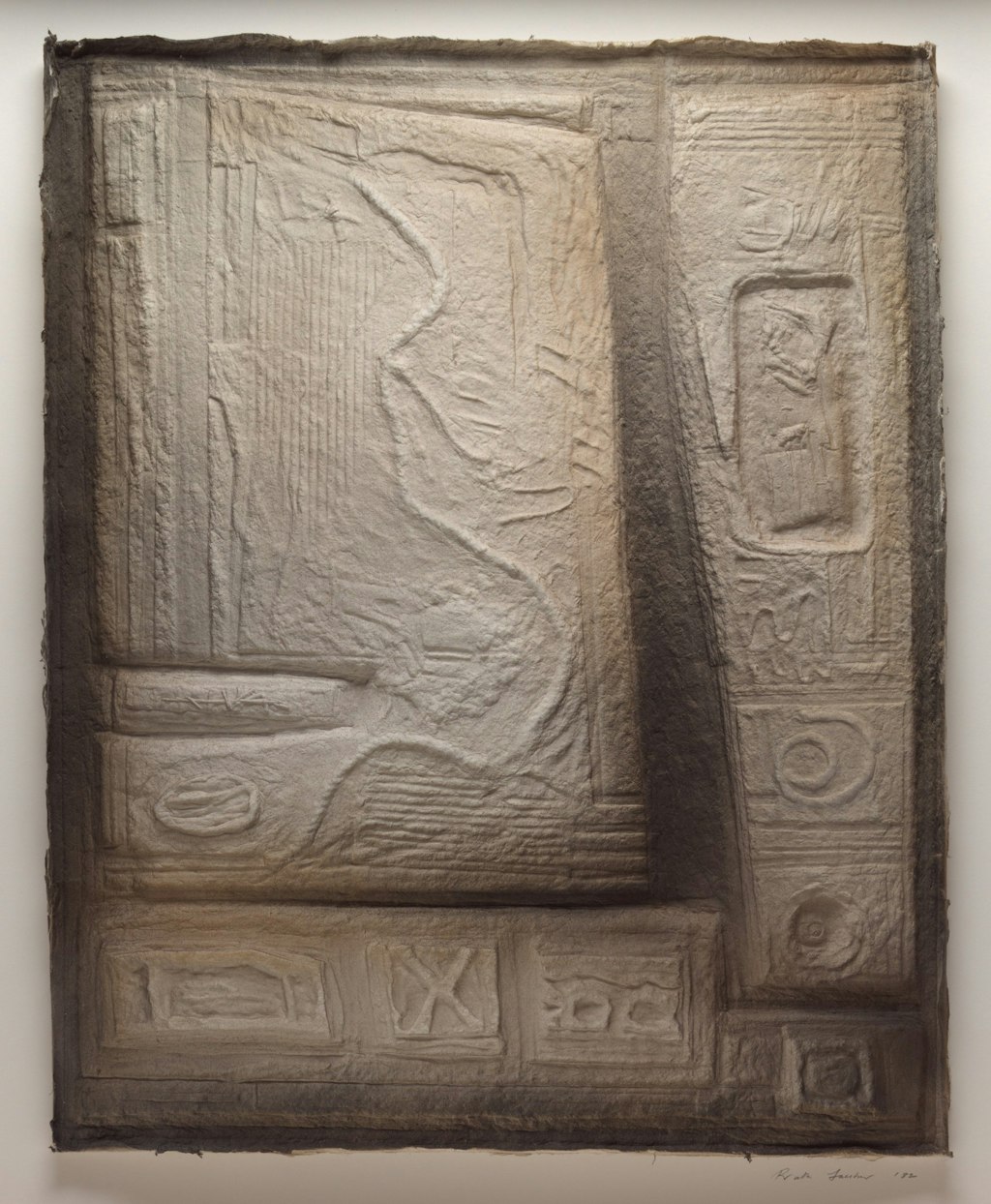 A moulded shape that resembles stone, imprinted with shapes like ancient glyphs