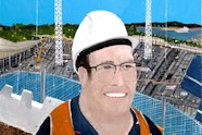 A person in a hard-hat and orange vest on a construction site