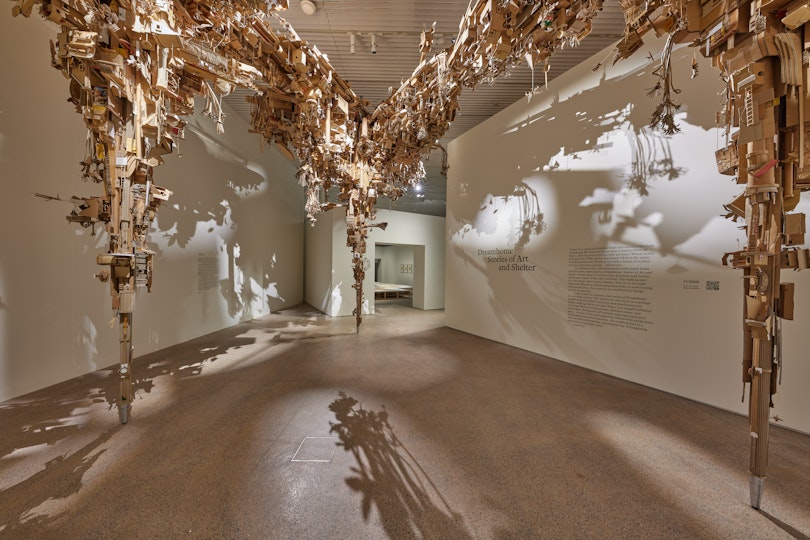 A sculptural installation suspended from the roof of a gallery space