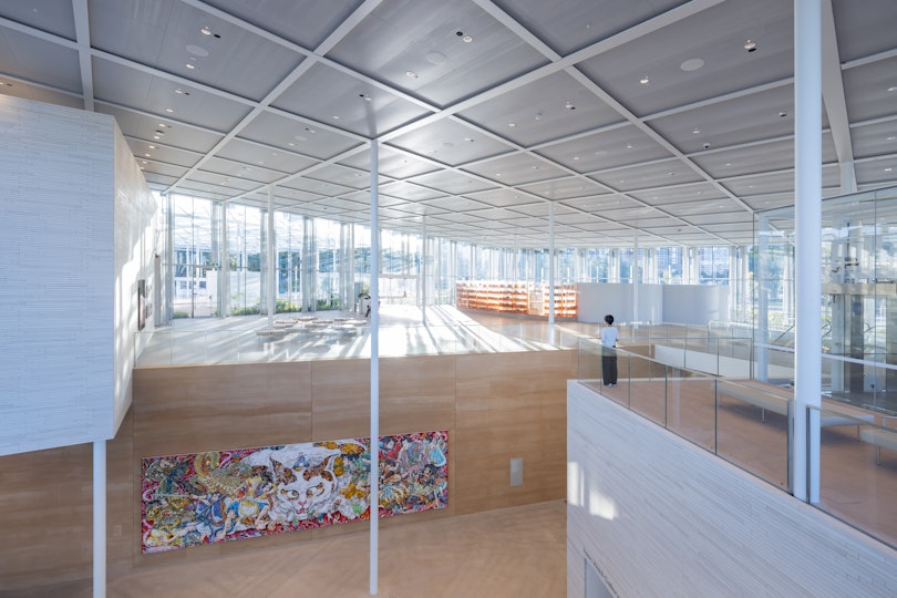 Inside a large, glass-walled gallery space