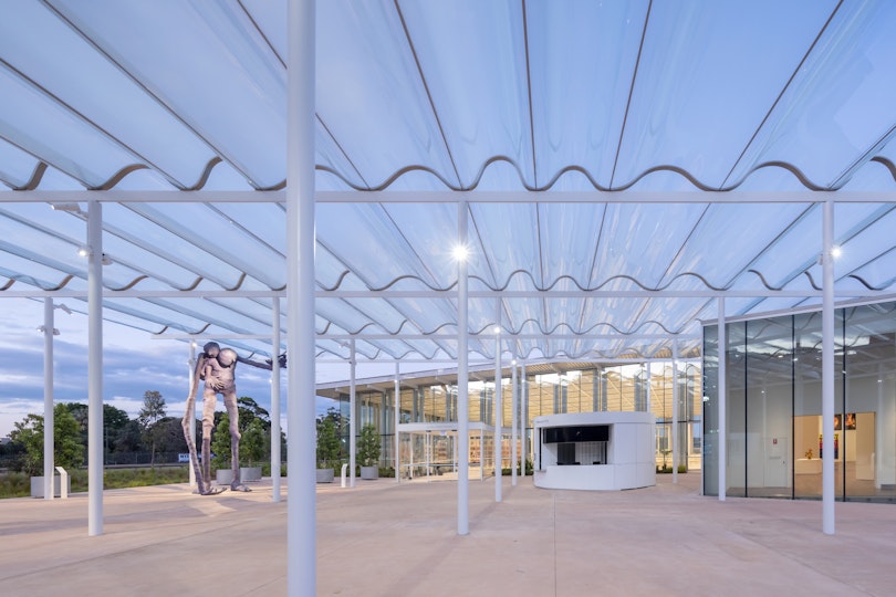 Exterior view of the Welcome Plaza of the Art Gallery of New South Wales’ new building, featuring Francis Upritchard Here Comes Everybody 2022, photo © Iwan Baan