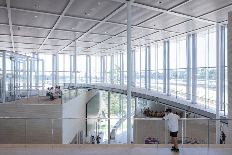 People inside a large glass-walled building